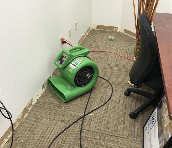 Medical Office with fan on carpet and baseboards removed