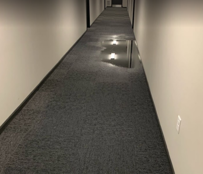 standing water in hallway of commercial building 