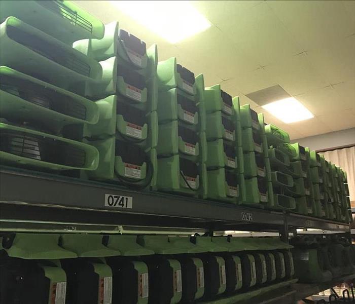 Air Movers stacked on shelving