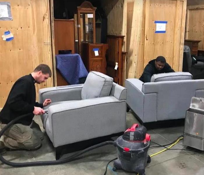 technicians cleaning furniture affected by a fire